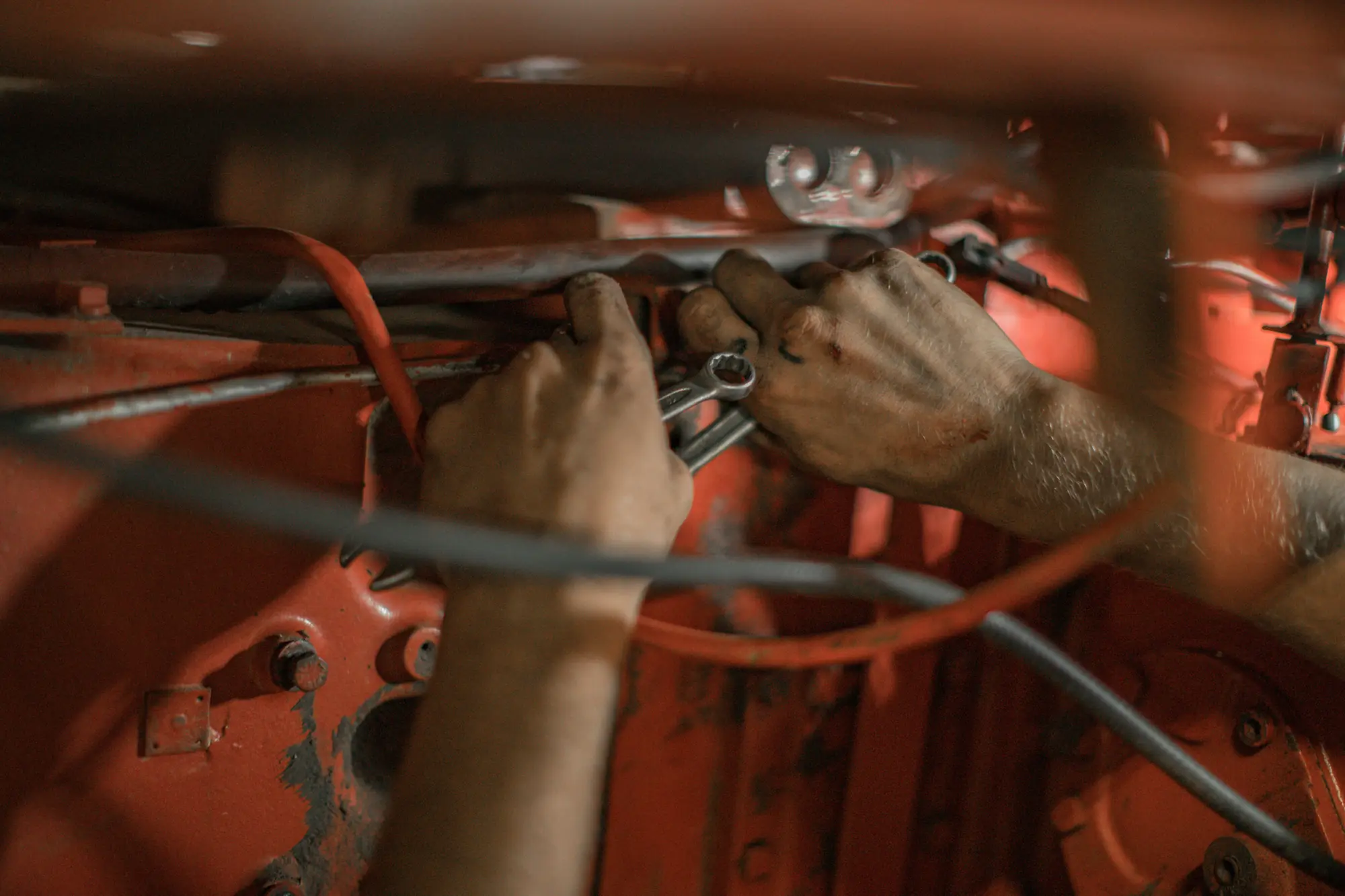 Hands working on engine wiring